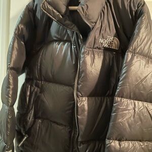 The North Face Women's Black Puffer Jacket
Note:pin hole size spot in picture